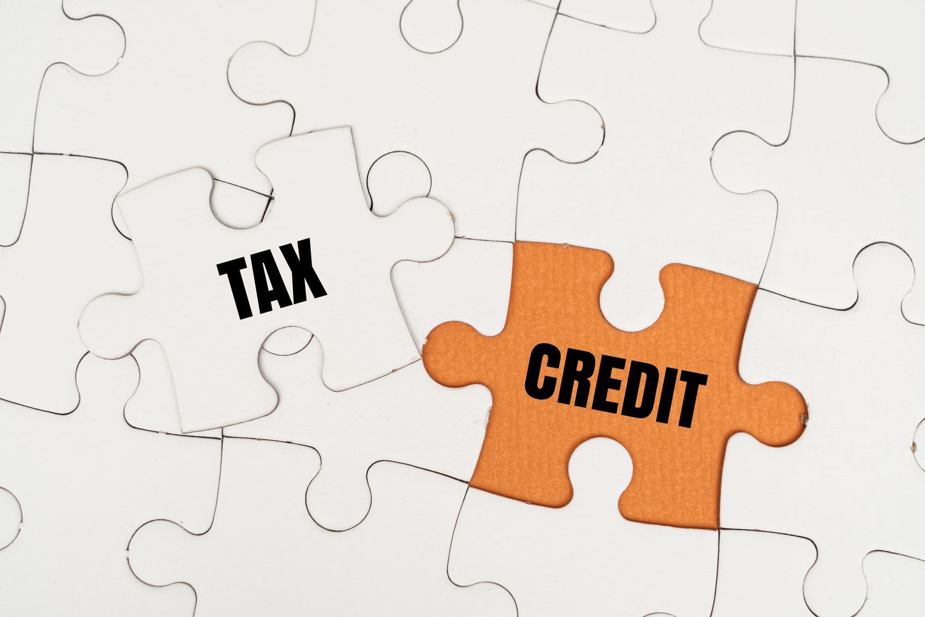 A jigsaw with the words tax and credit