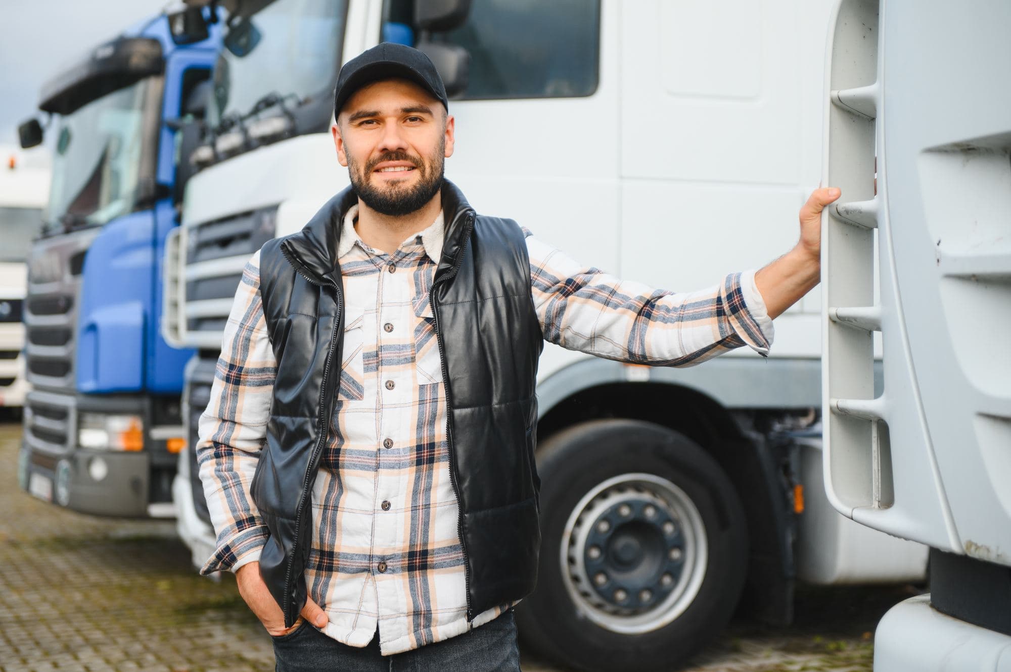 An owner-operator standing beside his lorry